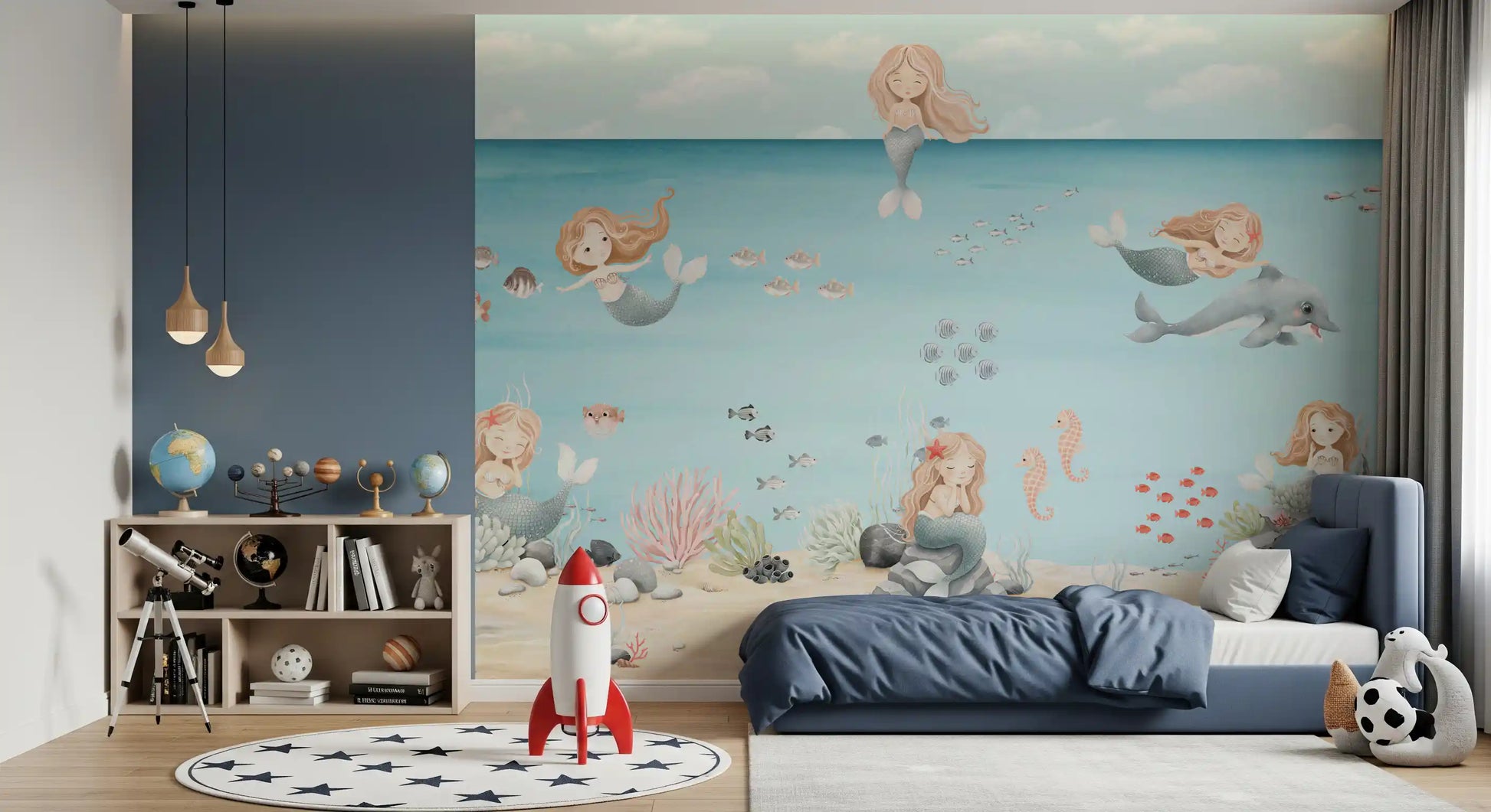 Boys Bedroom cot sits below mermaids and a dolphin on the Lagoon Dreams wall mural