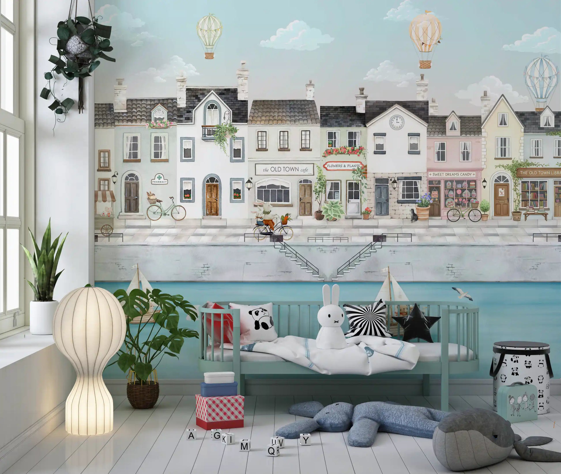 Toddler room shows sailboats and balloons across the Quaint Canal Town wall mural