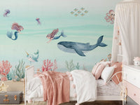 Girls' bedroom with coral reef and sea creatures across the Ocean Dream wall mural