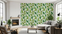 Green fern fronds within a lounge setting on the natural white wallpaper.