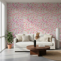 Gentle pink and coral blooms drift across the lounge wallpaper, free and loose