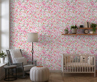 Daisy heads cluster on the Nursery wallpaper, with pink, coral and peach tones