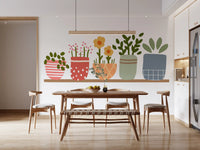 Patterned pots and leafy stems sit across the wall mural in a Dining room 