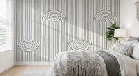 Slim vertical stripes climb the Linear Rhythm Arches wall mural inside a bedroom corner.