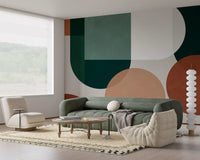 Living room wall mural with earthy geometry, green forms, and clay accents