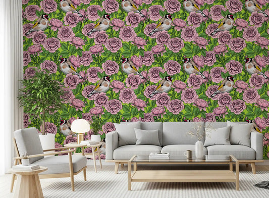 Pink roses and finches fill the Goldfinch Rose Garden wallpaper in a living room.