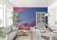 Twilight sky wall mural featuring floating flowers and clouds