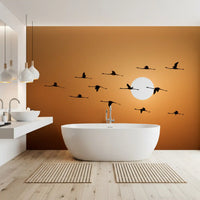 Golden horizon wall mural with birds flying across the sky