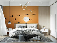 Golden sky wall mural with elegant birds in flight silhouette
