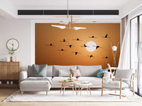 Sunset inspired wall mural with flock of birds and warm hues