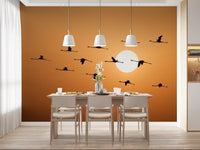 Landscape wall mural featuring birds above a glowing horizon