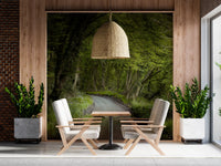 Nature wall mural with winding path through green forest