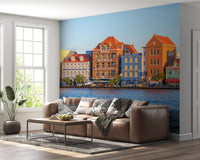 Coastal town wall mural with reflections across the harbour