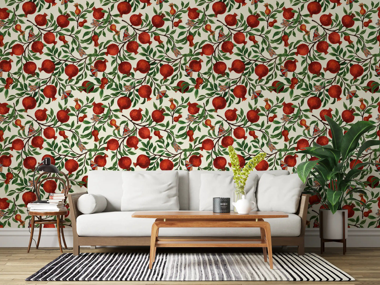 In a Living room, Pomegranate Orchard wallpaper layers ruby fruit and patterned moths.
