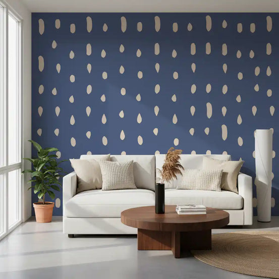 Cream droplets scatter over a dusty blue living room wall mural in mid-century mood.