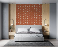 Burnt rust holds rows of ivory teardrops, a quiet repeat in the Seed Dots wall mural.