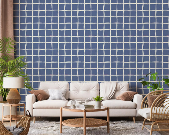 Dusty blue squares sit behind a calm living room in this wavy grid wallpaper.