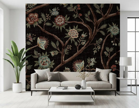 Dark chintz florals climb a living room scheme through the tree wall mural.