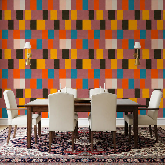 The Sunwashed Desert Sunset Wallpaper fills a dining room with bold colour blocks.