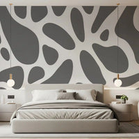 Gray fluid shapes stretch over a calm bedroom in this wall mural, GD10805