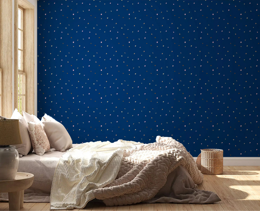Gold and pink flecks fill a bedroom in the Midnight Confetti wallpaper, GD10823