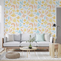 Wallpaper in a living room holds pastel leaves and flowers on white GD11600