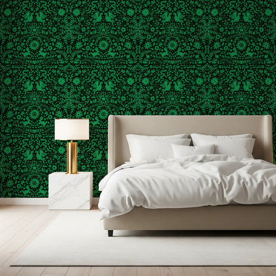 Forest folk botanical wallpaper behind a beige upholstered bed with a brass lamp GD12264