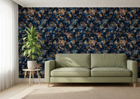 Navy botanical wallpaper behind a sage green leather sofa and leafy plant GD12284