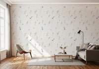 Pressed grasses wallpaper behind a grey sofa and tan lounge chair on a wood floor GD12291