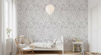 Grey botanical foliage wallpaper in a child's room with a cane chair and white bed GD12337