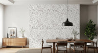 Muted grey botanical foliage wallpaper in a dining room with a wood table and black pendant GD12337