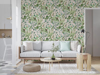 Soft sage floral meadow wallpaper in a living room with a grey sofa beside the kitchen GD12339