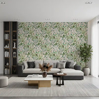 Sage floral meadow wallpaper behind a grey sofa with a bookshelf and coffee table GD12339