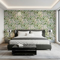 Soft sage floral meadow wallpaper in a bedroom with a dark grey bed and bedside lamps GD12339