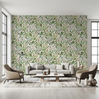 Soft sage floral meadow wallpaper in a bright lounge with a cream sofa and accent chairs GD12339
