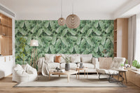 Green pineapple leaf wallpaper in a lounge with a cream curved sofa and wood pendants GD12340