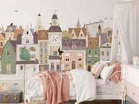 Village townscape wall mural above a pink girls bed with a canopy and soft pink throw GD12398