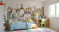 Cat and dog village mural in a bedroom with blue bedding, a wooden desk and green chair GD12398