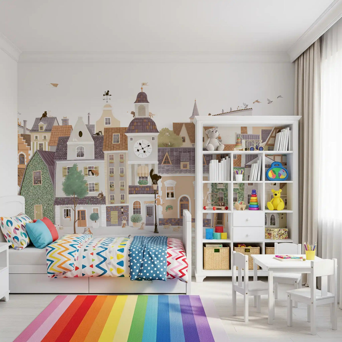 Pastel village townscape mural above a rainbow striped rug and a white play table GD12398