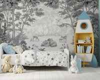 Enchanted woodland mural behind a bed with star bedding and a blue rocket bookshelf GD12399