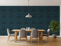 Teal leaf motif wallpaper in a dining room with wood table and grey chairs GD12456