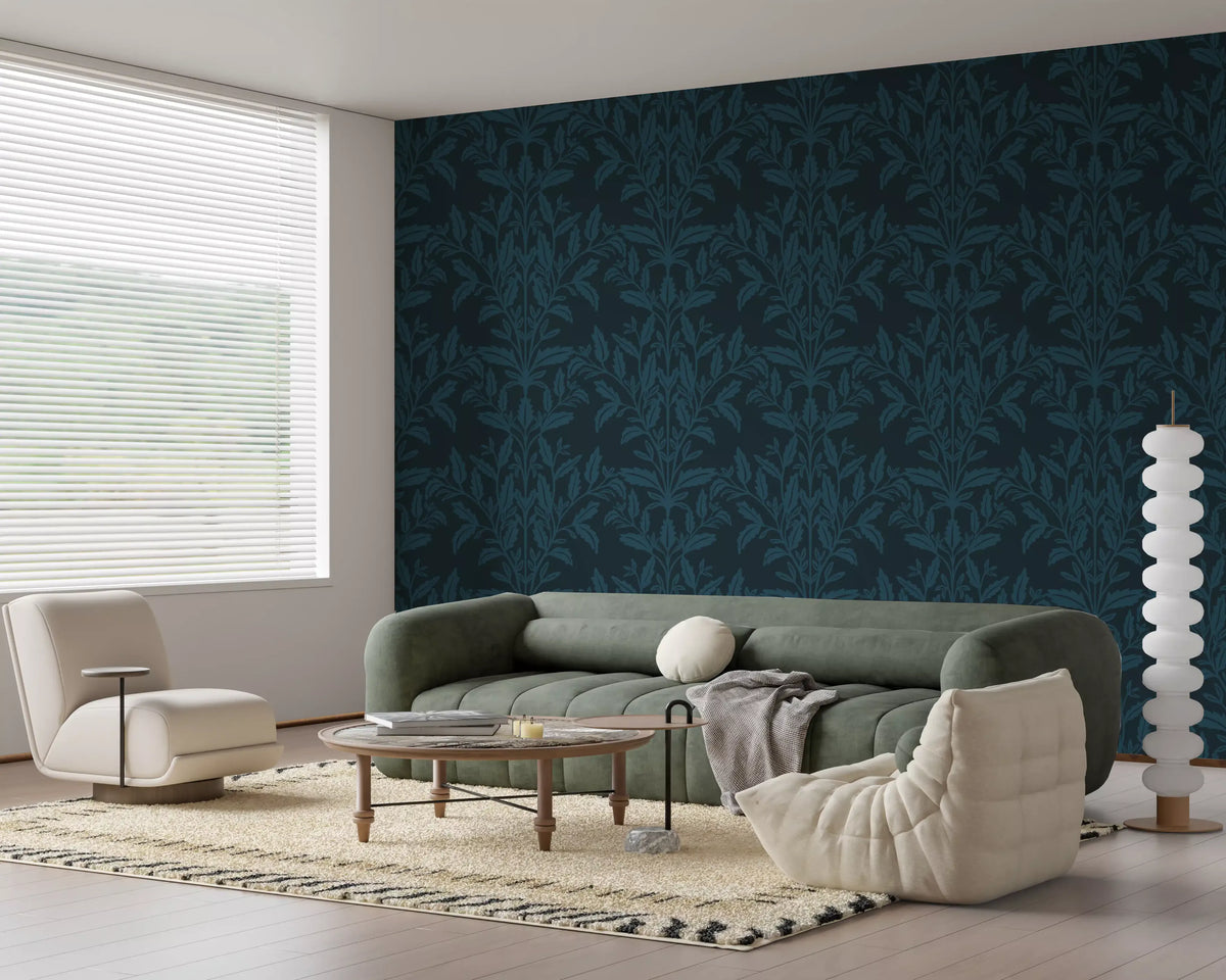 Ink leaf motif wallpaper in a living room with sage sofa and cream lounge pouffe GD12456
