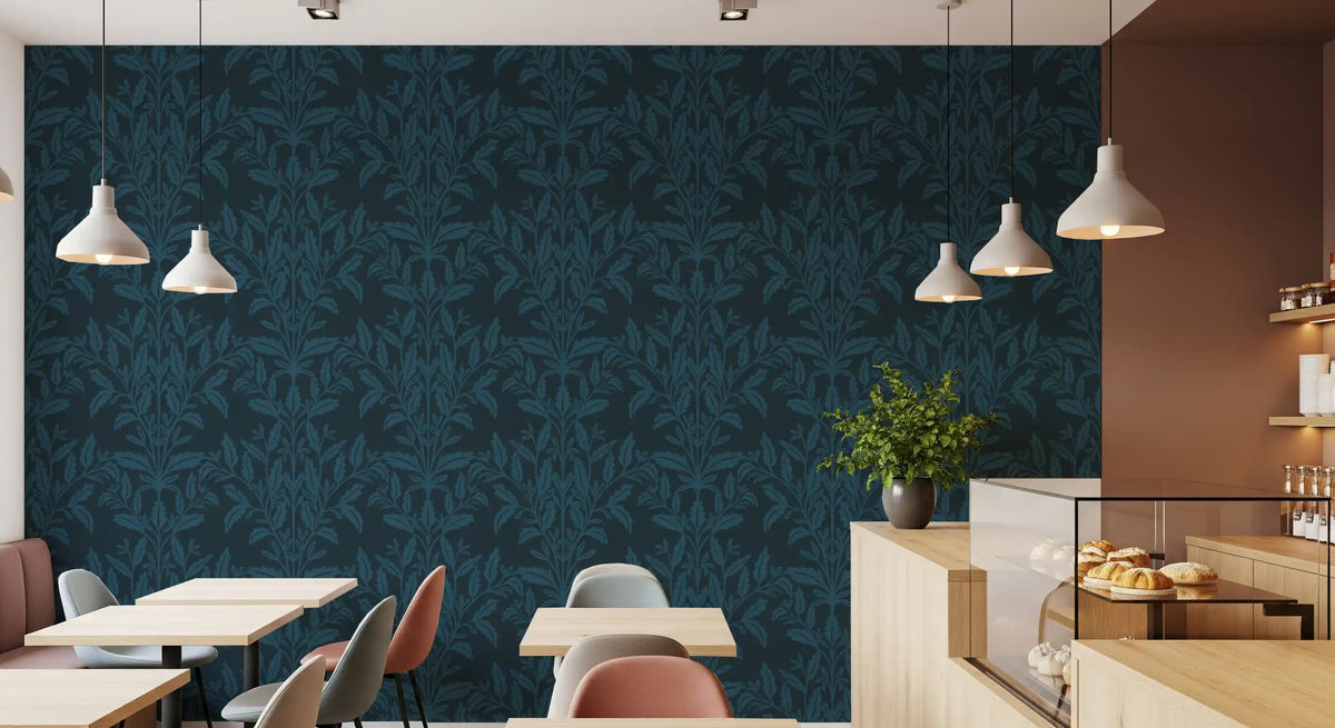 Dark leaf wallpaper along a cafe wall with wood tables and pendant lamps GD12456