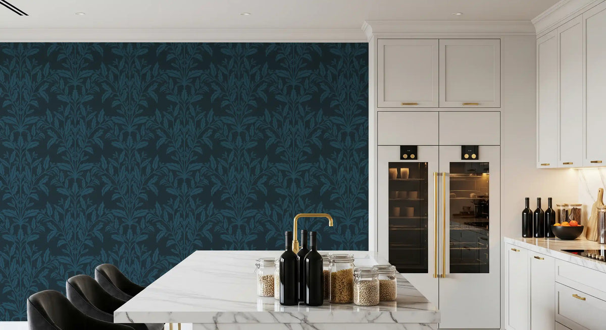 Ink leaf motif wallpaper in a white kitchen with marble island and gold tap GD12456