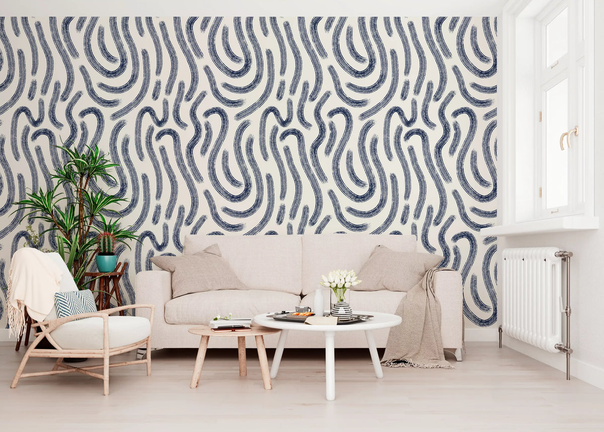 Indigo fluid lines wallpaper behind a cream sofa with a rattan armchair and round table GD12465