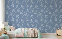Blue scribble arrows wallpaper behind a kids daybed with pastel throw and lamp GD12470