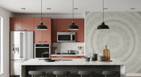 Dot ripple wall mural in a kitchen with terracotta cabinets and black bar stools GD12474