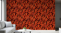 Tropical fronds wallpaper behind a grey sofa with a black round side table GD12477