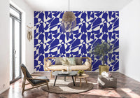 Abstract blue geometric wallpaper in a room with a black chair and terracotta tile floor GD12480