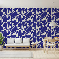 Blue geometric shapes wallpaper behind a white bench and a wooden dining table GD12480